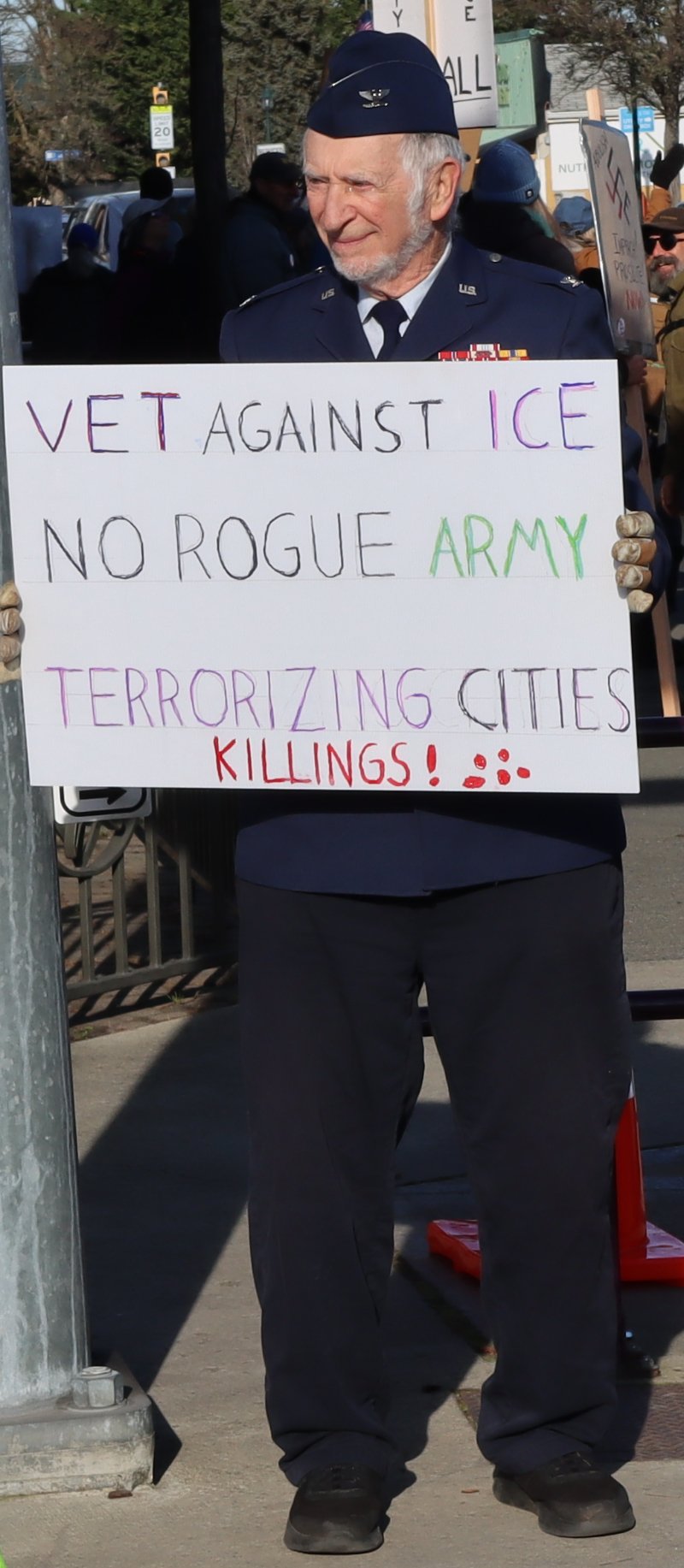 veteran holding sign