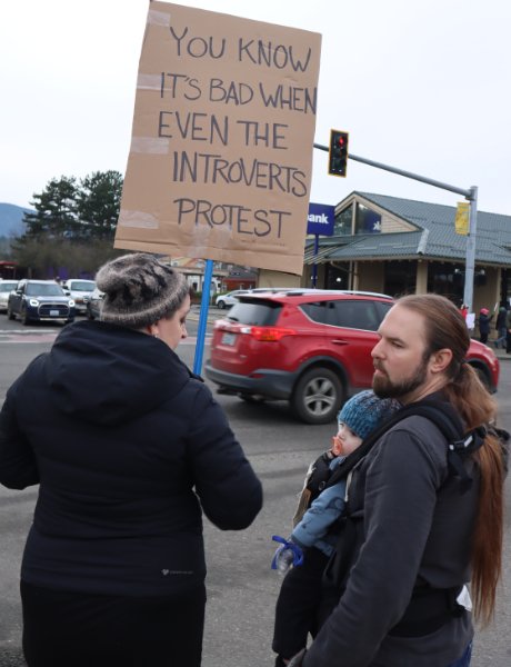 Woman holding sign: You know it's bad when even introverts protest